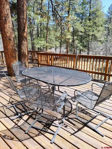 a view of a roof deck with wooden floor and fence