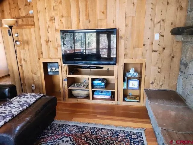 a living room with fireplace furniture and a rug