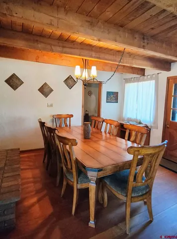 a dining room with furniture and wooden floor