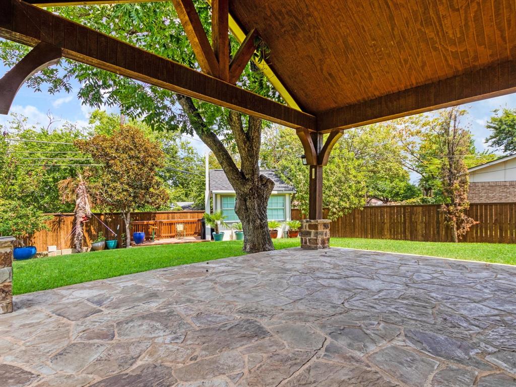 1616 Springbrook Street Mesquite, TX 75149 - Photo 22 of 24 Expansive outdoor patio with flagstone paving and a wood-beamed overhead structure