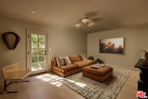 a living room with furniture a rug and a window