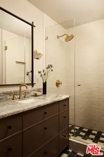 a bathroom with a granite countertop sink mirror and double