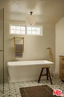 a living room with a table and a flat screen tv