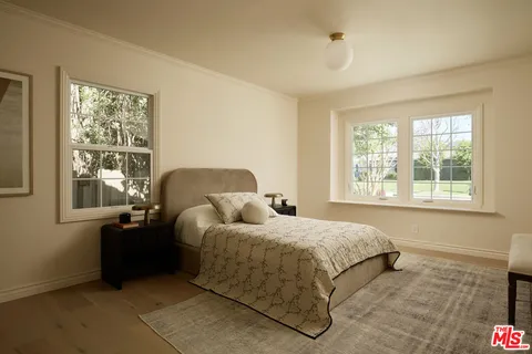 a bedroom with bed and window