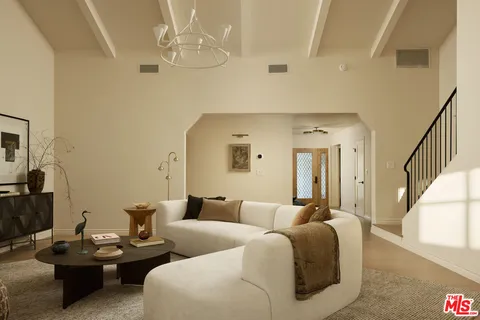 a living room with furniture and a chandelier