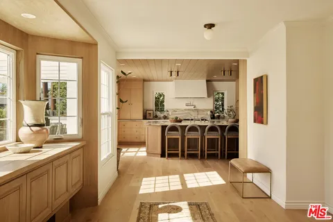 a large kitchen with a counter space a sink and a refrigerator