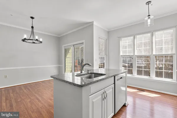 a kitchen with granite countertop a sink and a window