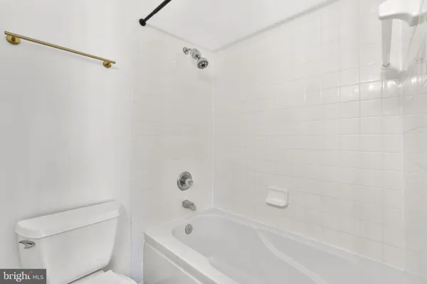 a bathroom with a bathtub and toilet