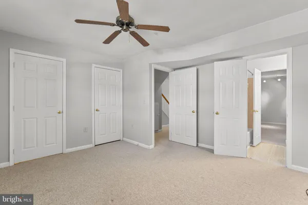 a view of empty room with ceiling fan