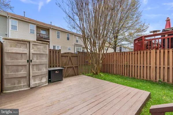 a view of a backyard with wooden fence