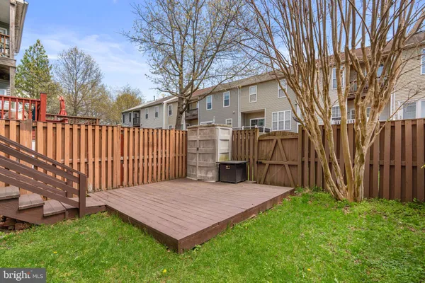 a view of a house with a yard and wooden fence