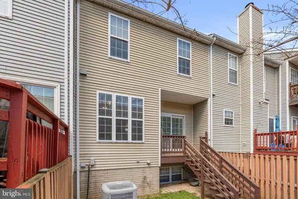 a view of a house with wooden deck