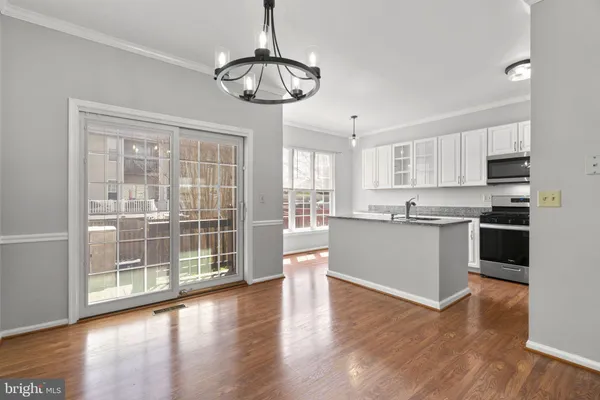 a view of kitchen with granite countertop cabinets a sink and appliances