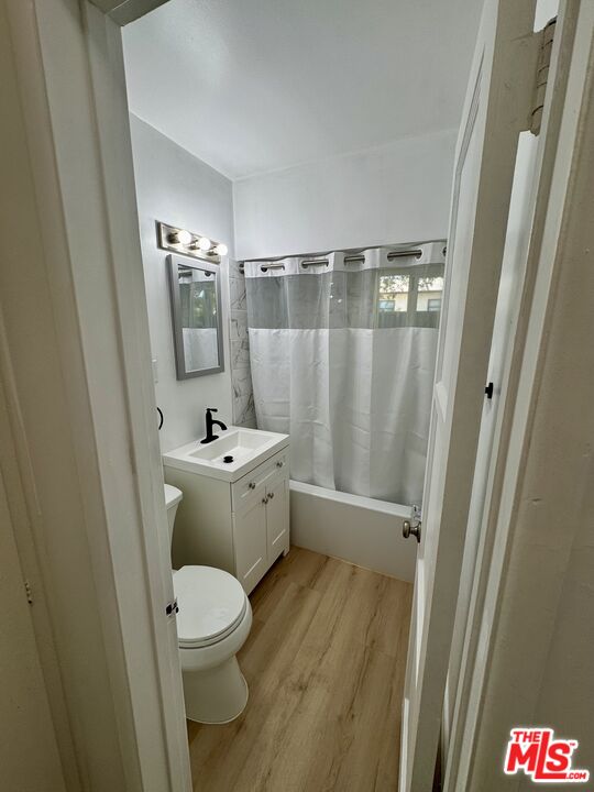 7733 Apperson Street Tujunga, CA 91042 - Photo 2 of 13 a bathroom with a sink a toilet a mirror and shower