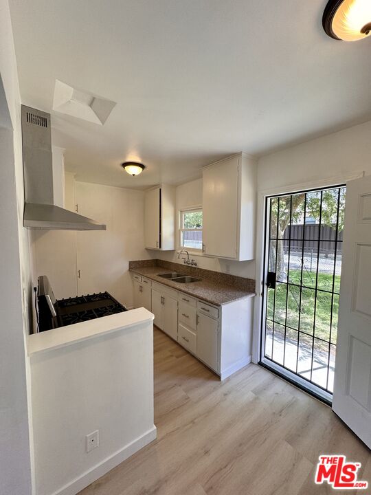 7733 Apperson Street Tujunga, CA 91042 - Photo 8 of 13 a kitchen with stainless steel appliances granite countertop a stove a sink and a microwave