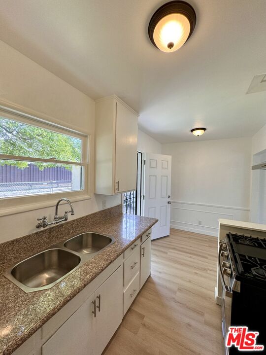 7733 Apperson Street Tujunga, CA 91042 - Photo 9 of 13 a kitchen with granite countertop a sink and a stove