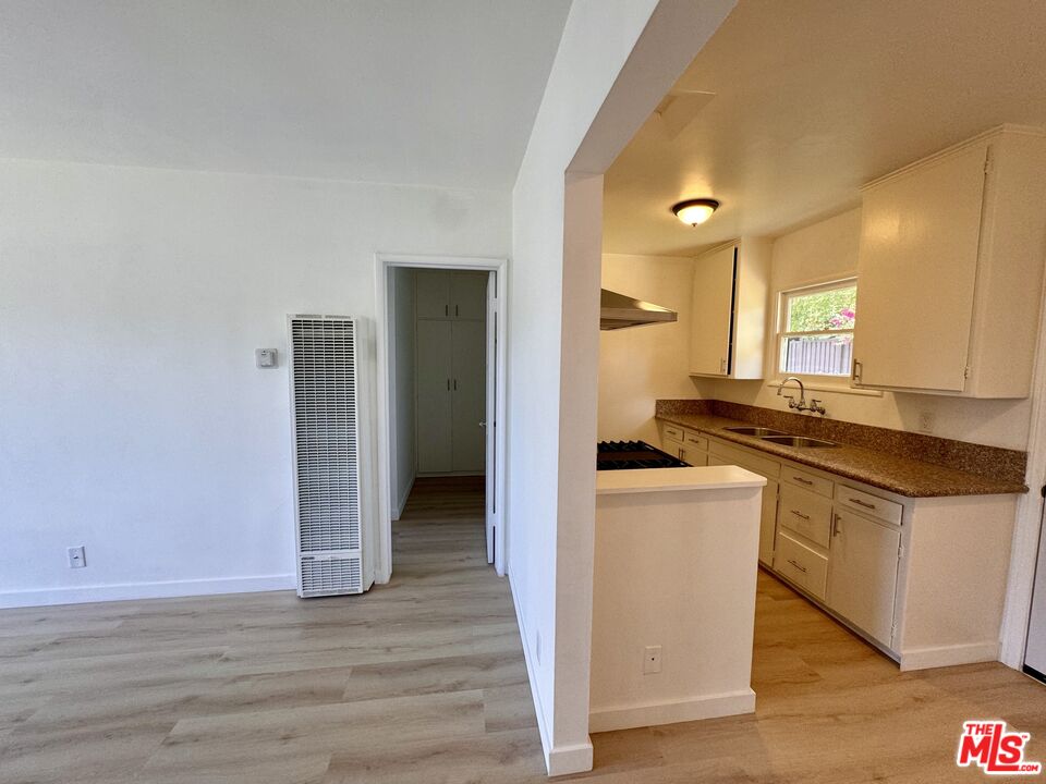 7733 Apperson Street Tujunga, CA 91042 - Photo 10 of 13 a kitchen with stainless steel appliances granite countertop a sink and a refrigerator