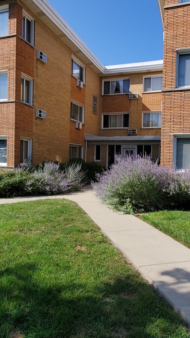 1619 West Howard Street, Unit B3 Chicago, IL 60202 - Photo 1 of 13 a front view of house with yard and green space