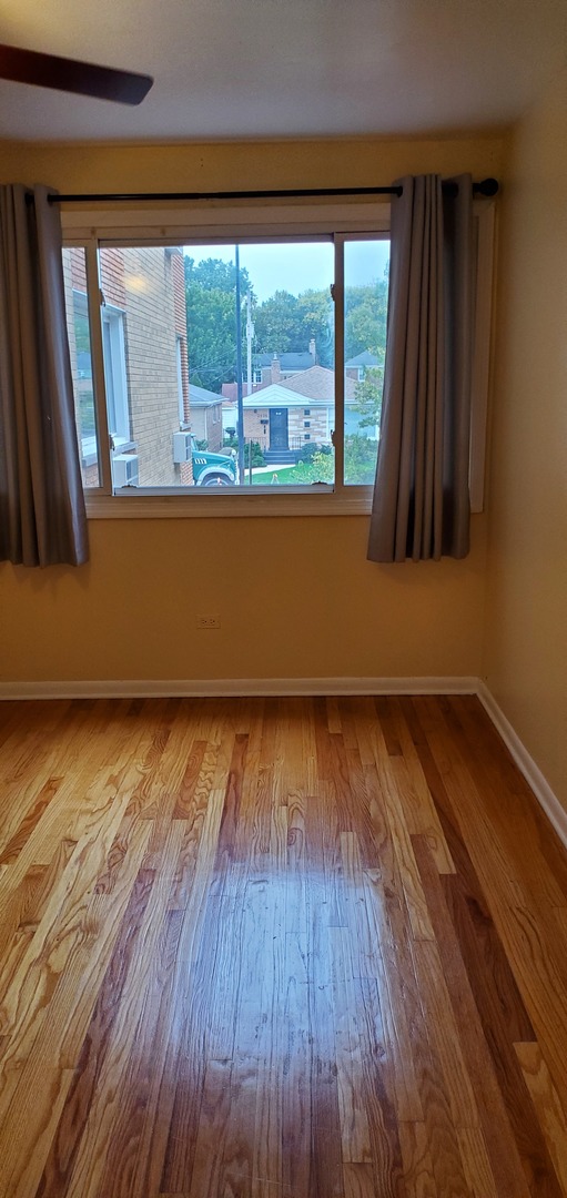 1619 West Howard Street, Unit B3 Chicago, IL 60202 - Photo 3 of 13 a view of a room with wooden floor and a large window