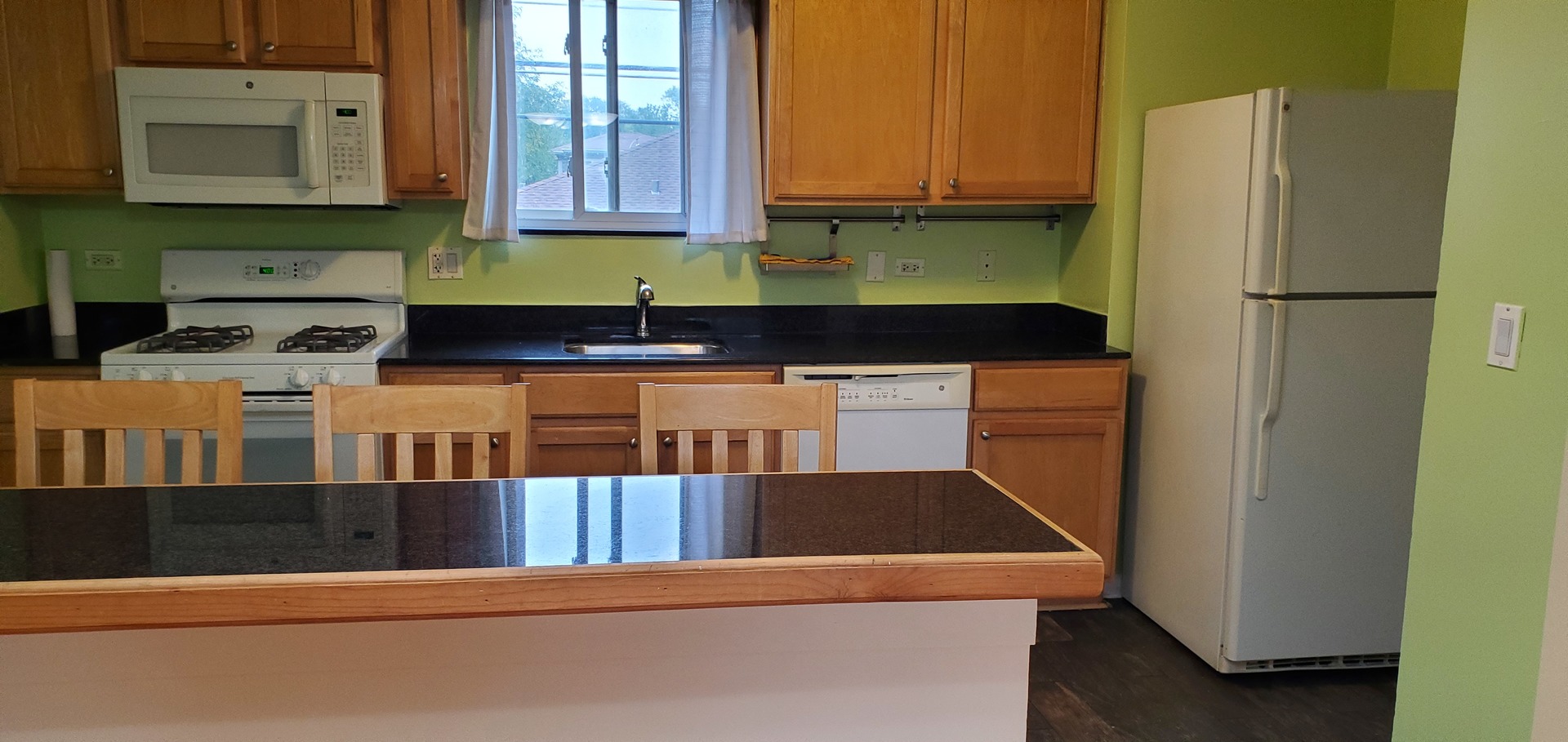 1619 West Howard Street, Unit B3 Chicago, IL 60202 - Photo 4 of 13 a kitchen with stainless steel appliances granite countertop a refrigerator a stove and a cabinets