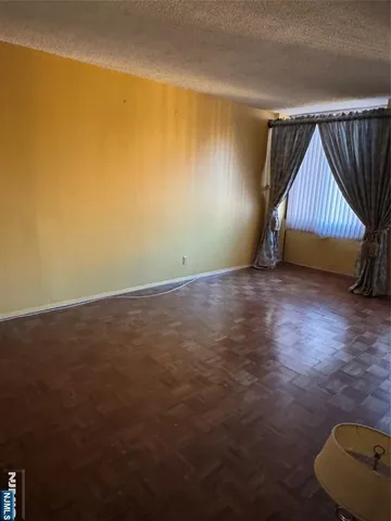 a view of a room with wooden floor and couch