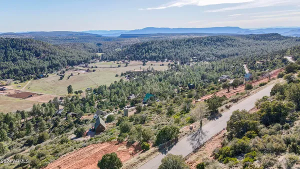 a view of a mountain with a field