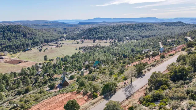 a view of a mountain with a field