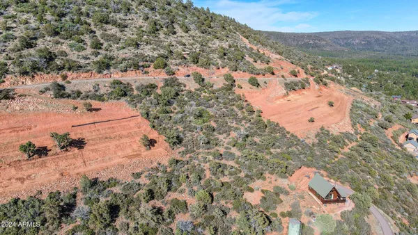 an aerial view of house with yard and mountain in the background