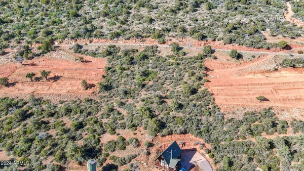 an aerial view of house with yard and mountain view in back