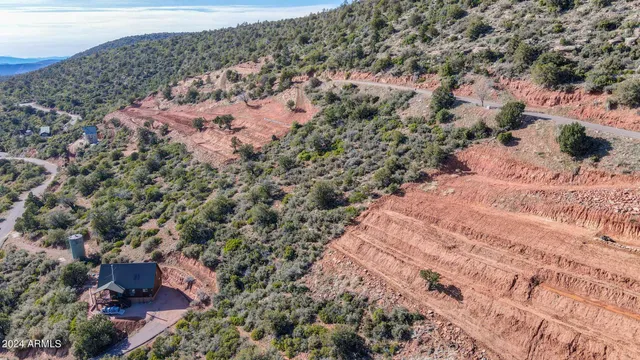 an aerial view of house with yard and mountain view in back