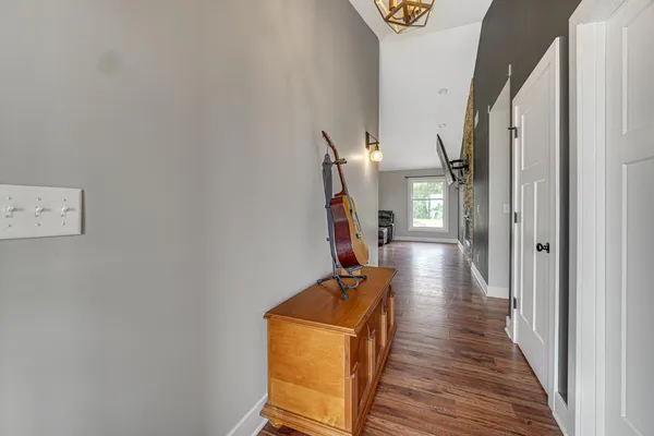 a view of a hallway with wooden floor and staircase