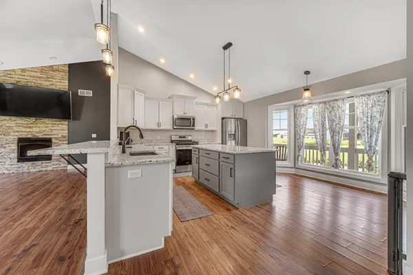 a kitchen with counter top space a sink appliances and cabinets