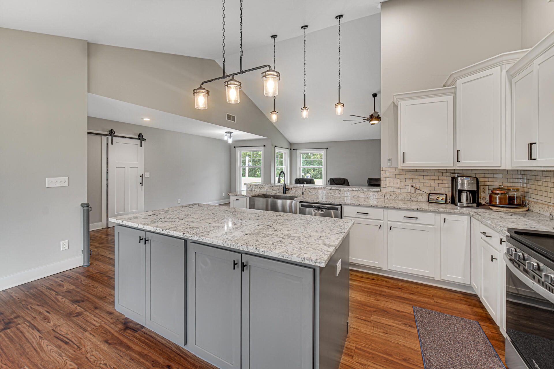 4455 Autumn Ridge Wheatfield, IN 46392 - Photo 18 of 33 a kitchen with stainless steel appliances granite countertop a sink a stove and a refrigerator