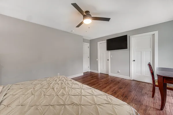 a bedroom with a bed and a flat screen tv