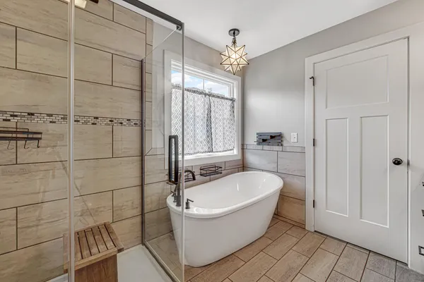 a bathroom with a bathtub and shower