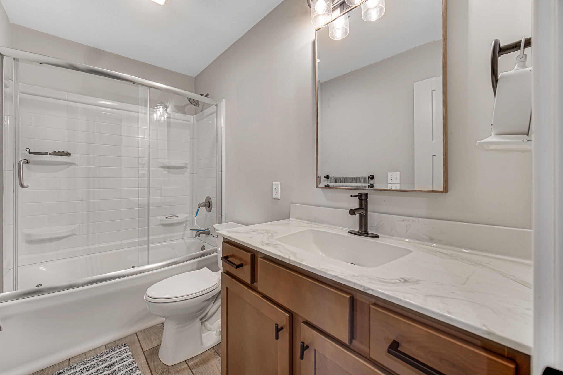 4455 Autumn Ridge Wheatfield, IN 46392 - Photo 27 of 33 a bathroom with a granite countertop sink a toilet and shower