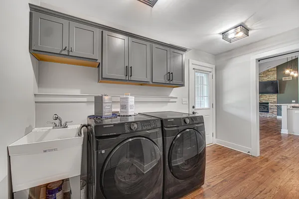 a utility room with sink dryer and washer