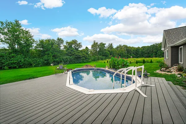 swimming pool view with a garden space
