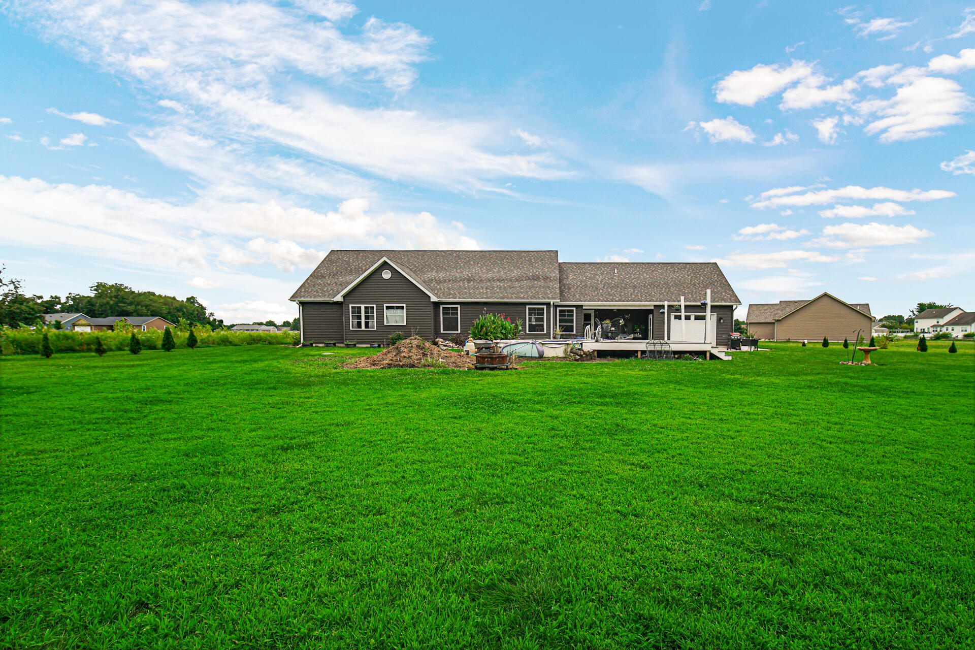 4455 Autumn Ridge Wheatfield, IN 46392 - Photo 6 of 33 a view of a house with a big yard and large trees