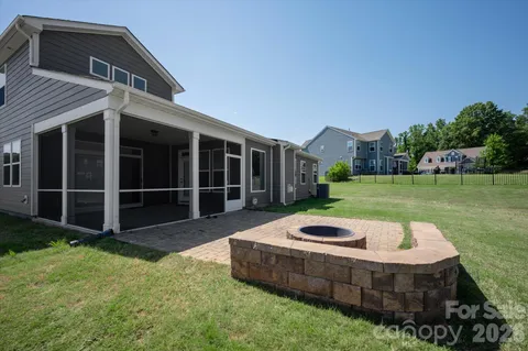 a view of a house with backyard and porch