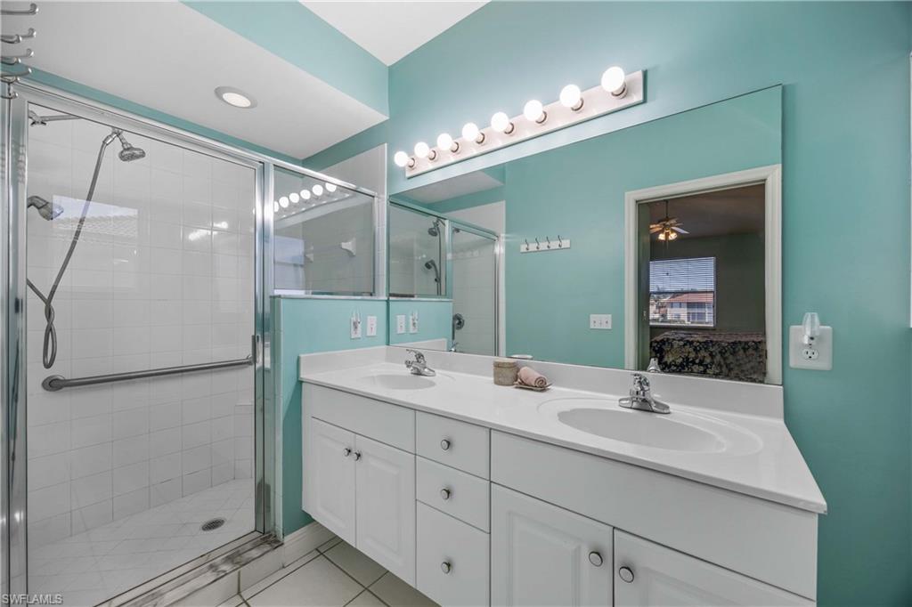 290 Robin Hood Circle, Unit 201 Naples, FL 34104 - Photo 17 of 34 a bathroom with a double vanity sink mirror and double