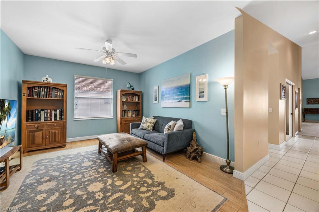 290 Robin Hood Circle, Unit 201 Naples, FL 34104 - Photo 20 of 34 a living room with furniture and a flat screen tv