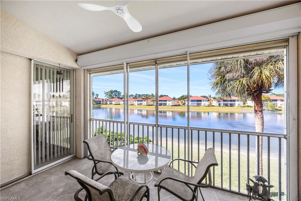 290 Robin Hood Circle, Unit 201 Naples, FL 34104 - Photo 21 of 34 a dining room with furniture water view and a floor to ceiling window