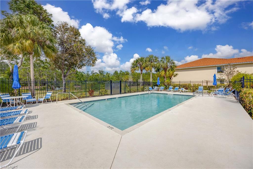290 Robin Hood Circle, Unit 201 Naples, FL 34104 - Photo 25 of 34 a swimming pool with outdoor seating and yard