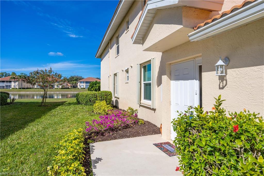290 Robin Hood Circle, Unit 201 Naples, FL 34104 - Photo 3 of 34 a view of a house with a yard and garden