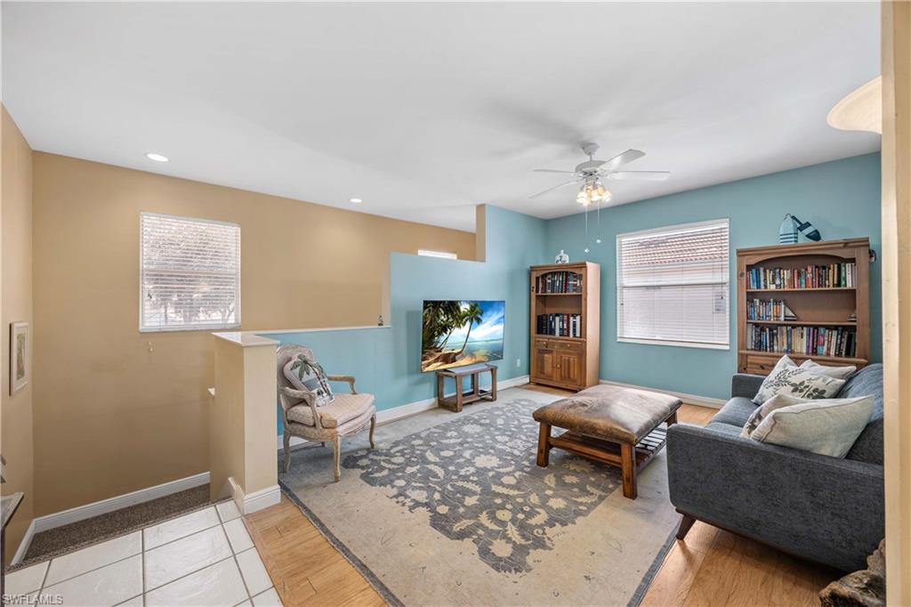 290 Robin Hood Circle, Unit 201 Naples, FL 34104 - Photo 4 of 34 a living room with furniture and wooden floor
