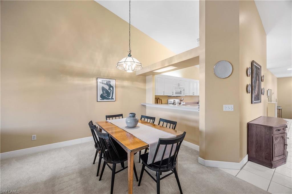 290 Robin Hood Circle, Unit 201 Naples, FL 34104 - Photo 9 of 34 a view of a dining room with furniture