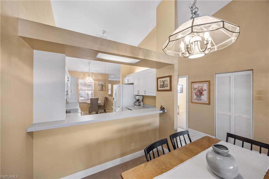 290 Robin Hood Circle, Unit 201 Naples, FL 34104 - Photo 10 of 34 a view of a living room and dining room