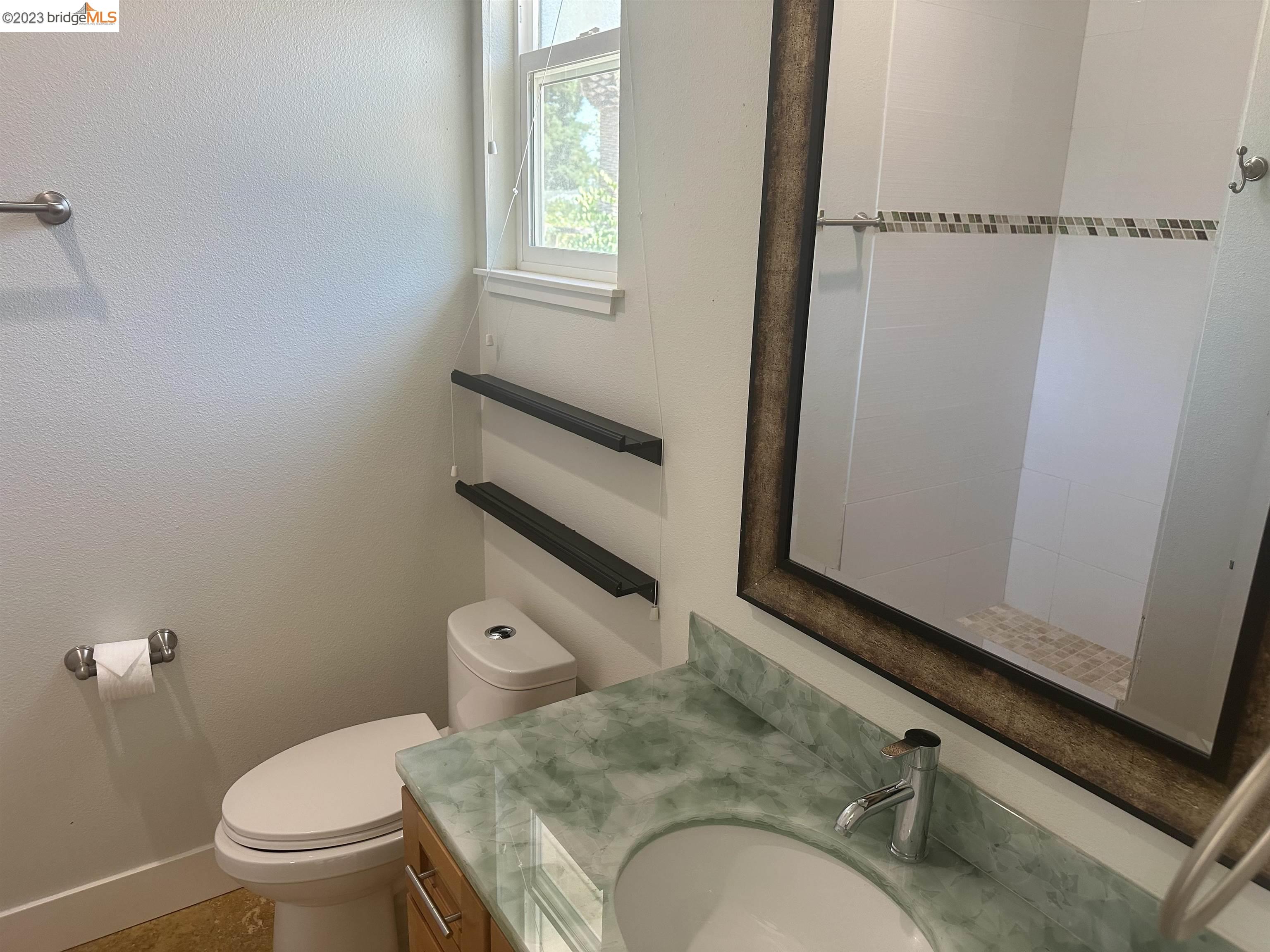 2191 Pleasant Hill Road Pleasant Hill, CA 94523 - Photo 11 of 35 a bathroom with a granite countertop toilet sink and mirror