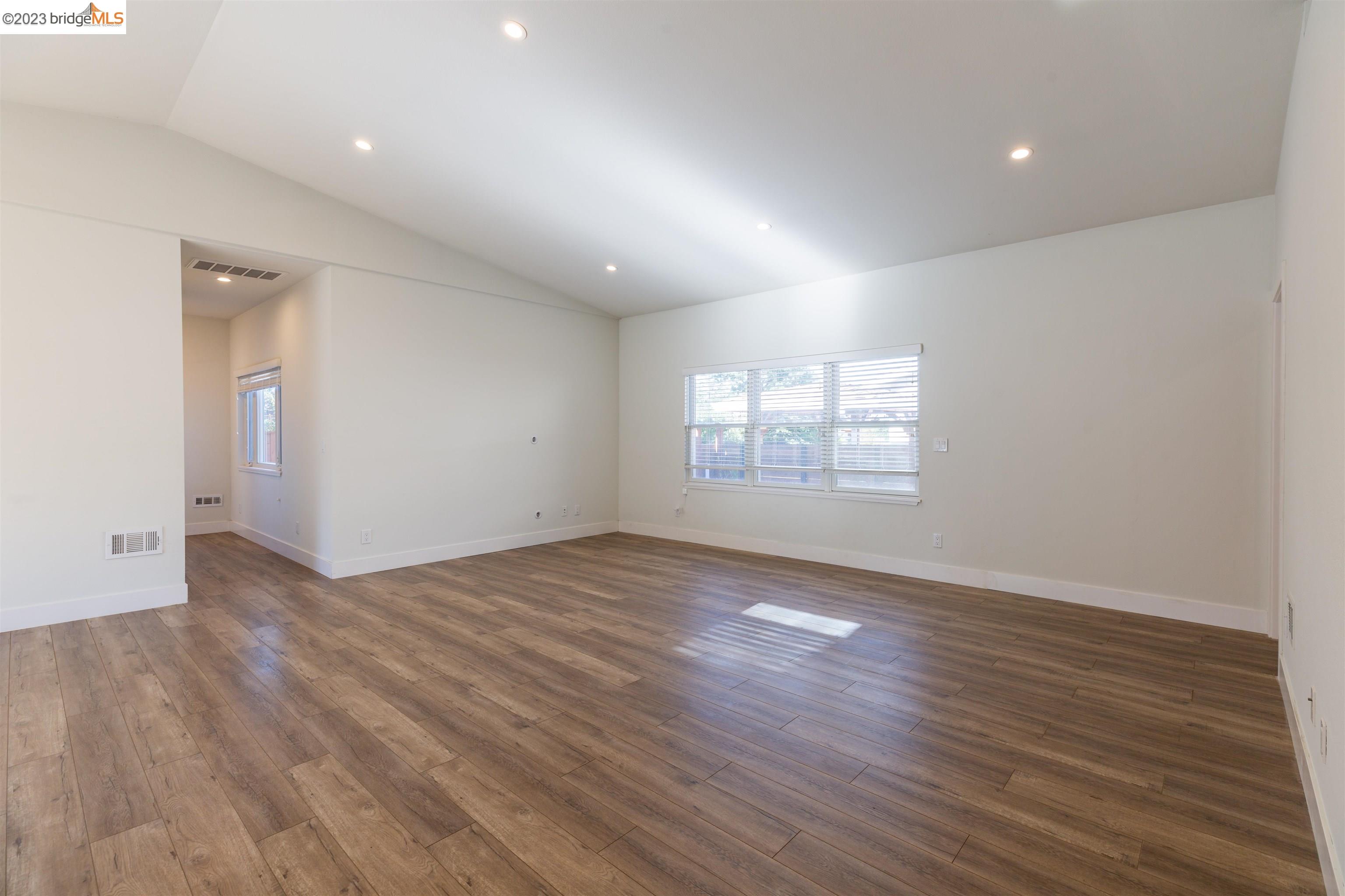 2191 Pleasant Hill Road Pleasant Hill, CA 94523 - Photo 18 of 35 a view of an empty room with wooden floor and a window